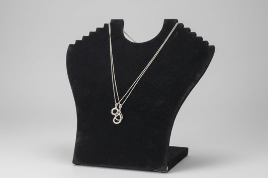Necklace with a pendant on a black display card against a white background