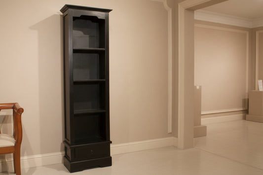 Tall black metal shelf against a wooden wall